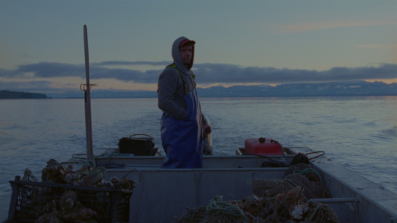 An oyster farmer in his boat